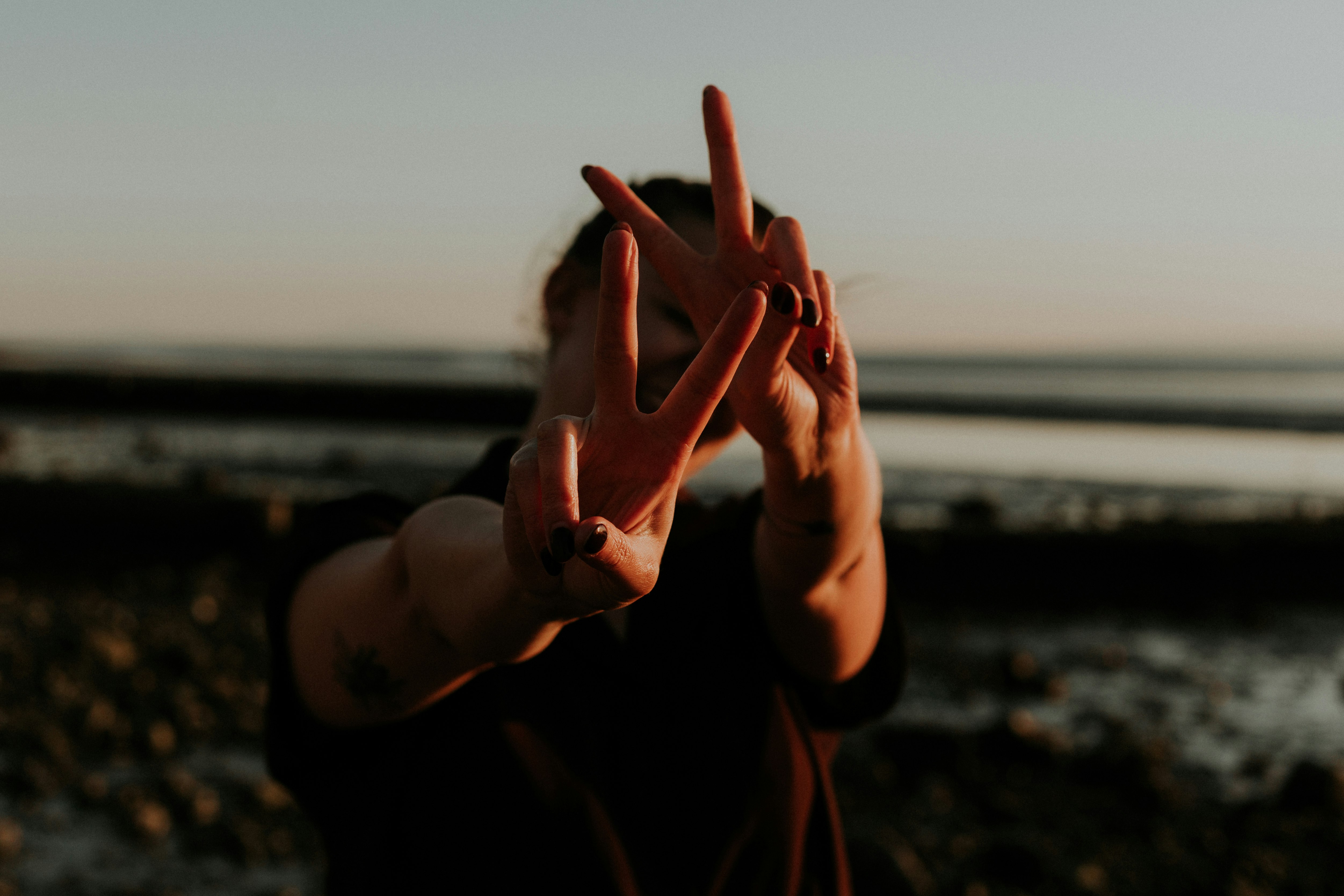 person in black long sleeve shirt showing right hand